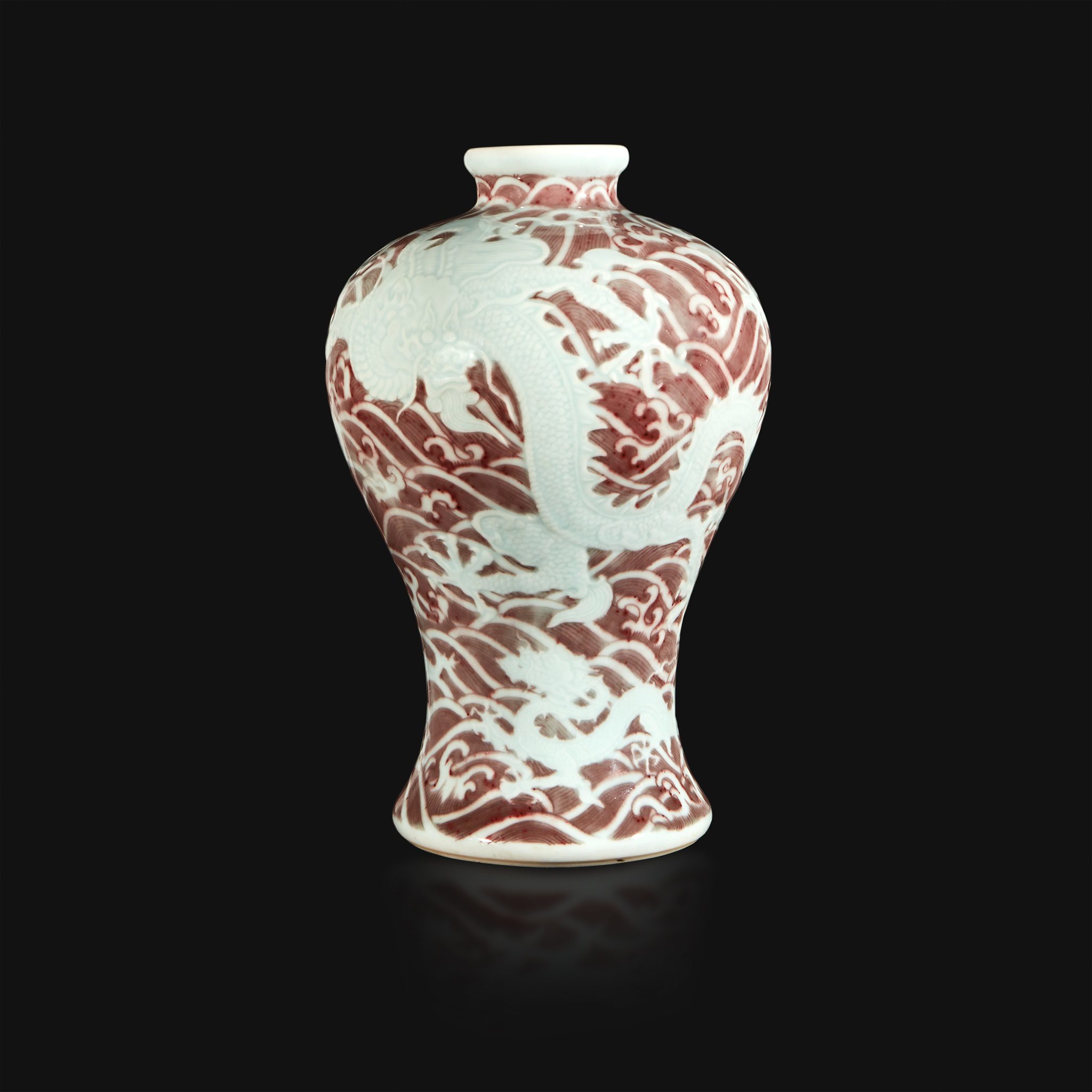 Chinese carved and underglaze red “Dragons and Waves” vase (Lot 12, $150,000-250,000) Freeman's Auction